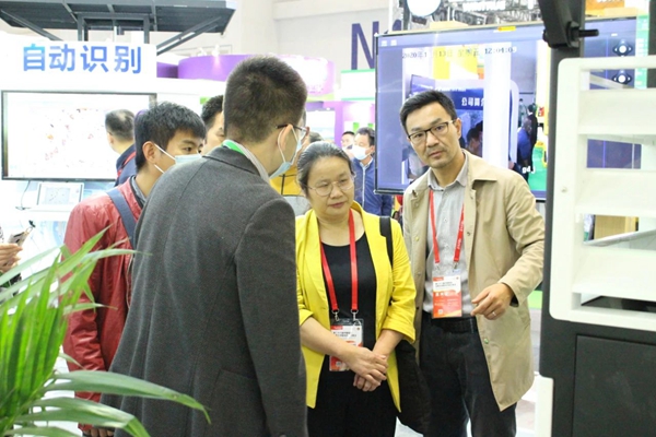 江西植保植检局钟玲局长（中）在麻将胡了展位相识新型测报设备